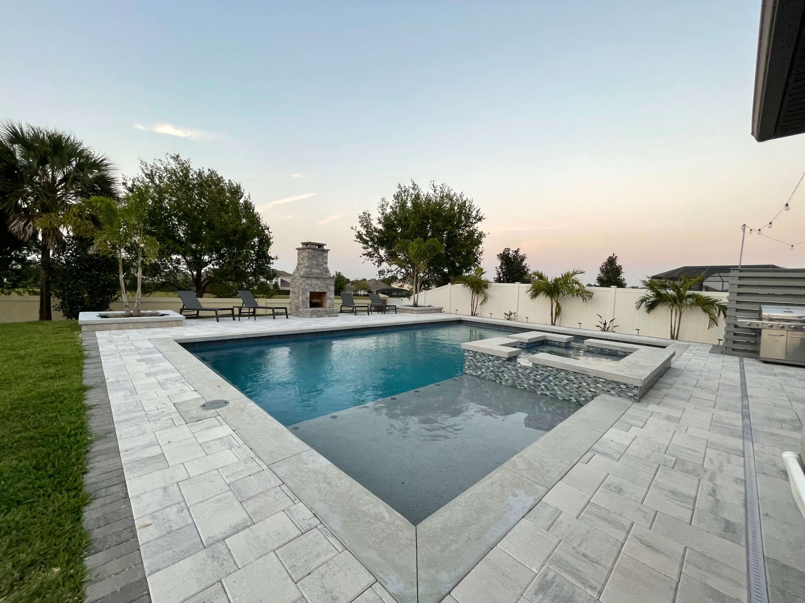 Geometric pool with raised tile spa
