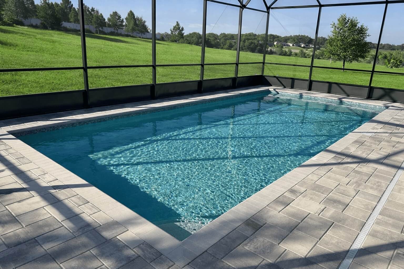 Geometric pool with paver deck in Clermont