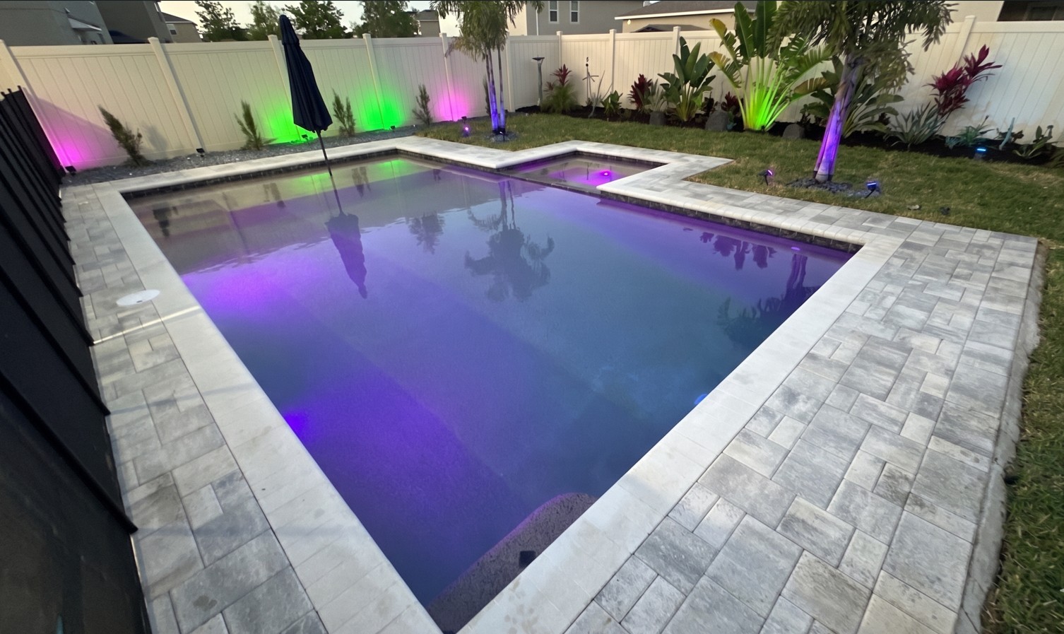 Geometric pool with LED lights and paver deck in Ocoee